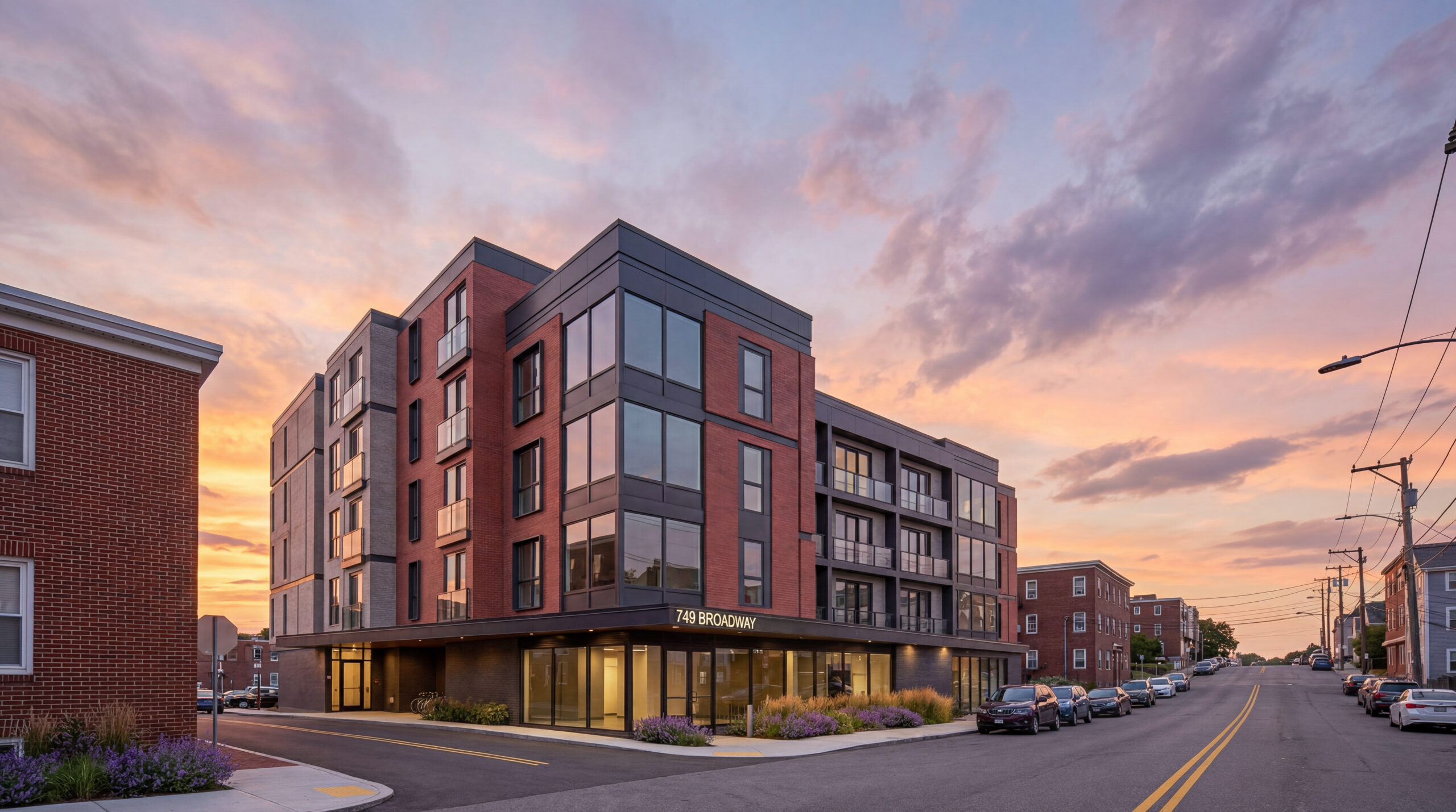 Front elevation rendering of a contemporary multifamily development with brick façade, recessed balconies, expansive glazing, and modern urban infill design in Boston<br />
