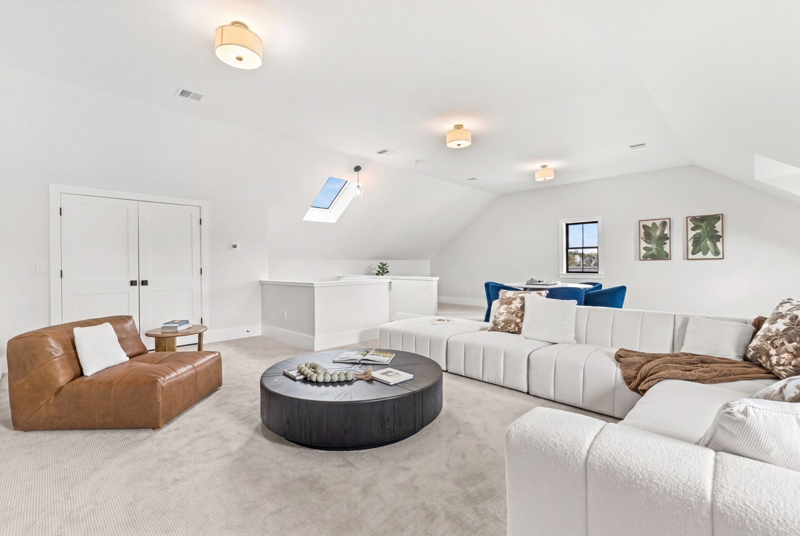 Bright upper-level living space with vaulted ceilings, skylight, plush sectional seating, and casual lounge area perfect for entertaining<br />
