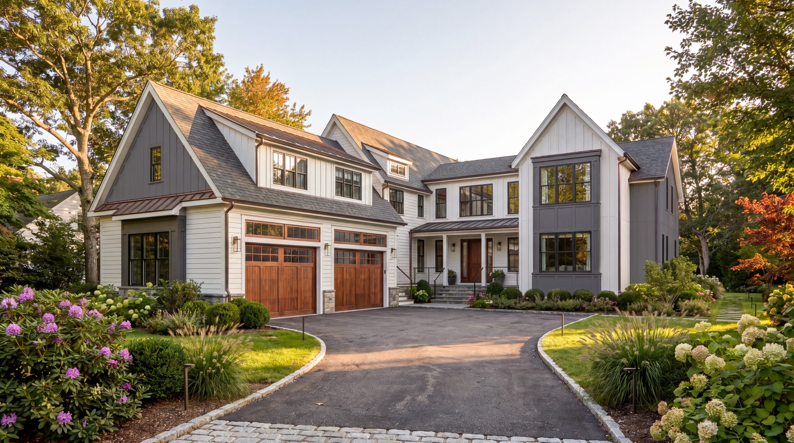 Luxury single-family residence featuring modern farmhouse architecture, board-and-batten siding, black-framed windows, wood garage doors, and professionally landscaped grounds in a suburban neighborhood.