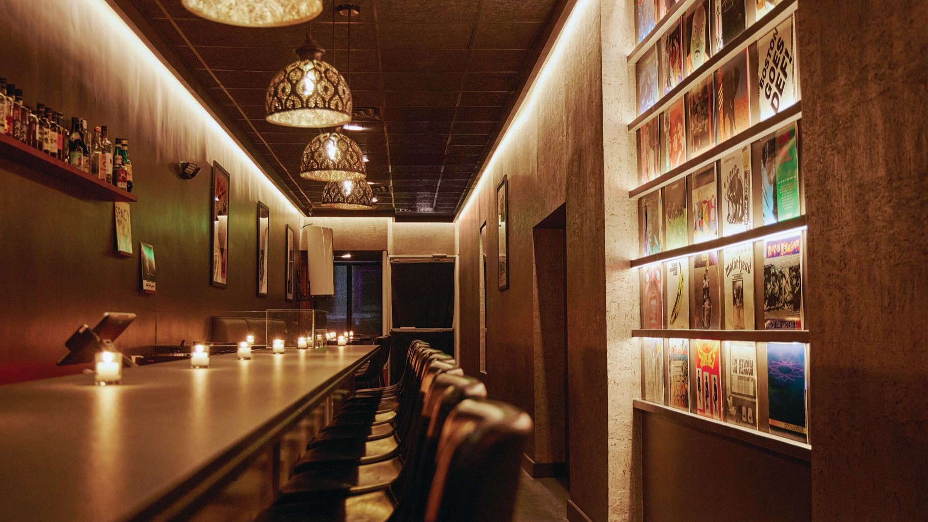 Warmly lit sushi den interior featuring a custom Hinoki wood omakase counter, minimalist seating, and refined Japanese-inspired detailing designed for an intimate dining experience.